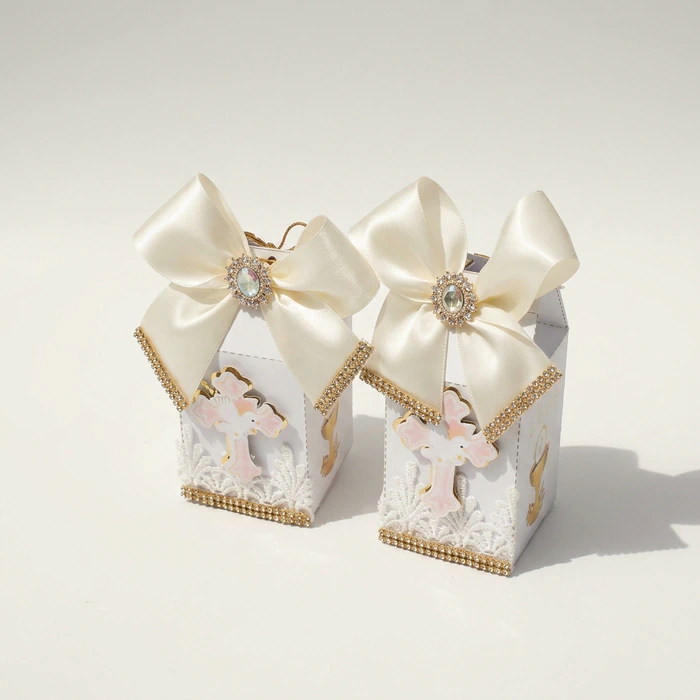 Two christening favour boxes with ivory bows, crystal brooches and gold trim